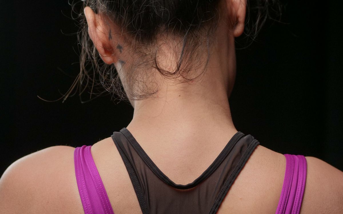 Close-up view of a woman's back wearing a sports tank top. Ideal for fitness and lifestyle themes.
